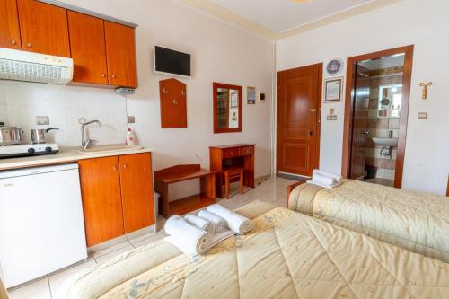 a kitchen with a bed and a sink in a room at VILLA Vasilios EXARHOS in Paralia Katerinis