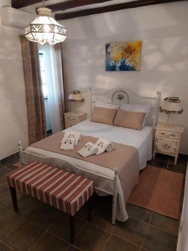 a bedroom with a white bed with towels on it at Monte Santiago in Fronteira