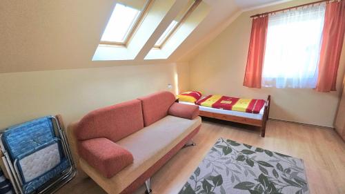 a living room with a couch and a bed at Willa Marand in Jastarnia