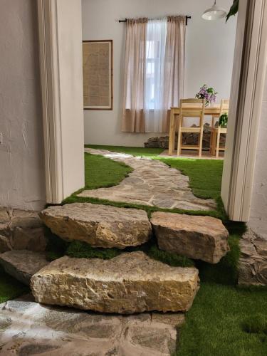a stepping stone path in a room with grass at Pajtl indoor glamping in Črna na Koroškem