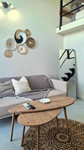 a living room with a couch and a wooden coffee table at Dris Loft in Nikiana