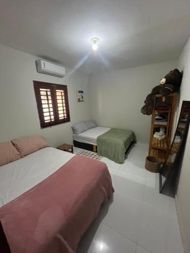 a bedroom with two beds and a window at Casa Flor e Ser Rua Onezinda da Costa Barros ,80 in Parnaíba