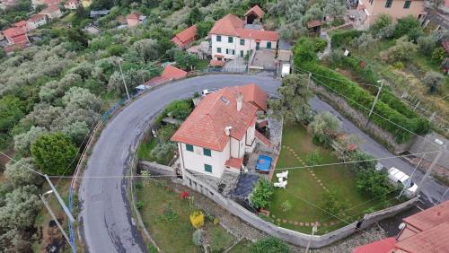 a large white house with a red roof and a road at Wildflowers House - JApartments in Genoa