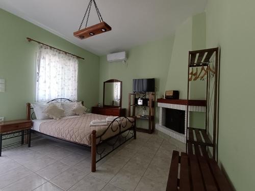 a bedroom with a bed and a fireplace at Forest Retreat Near the Sea Kouvaras in Kouvarás