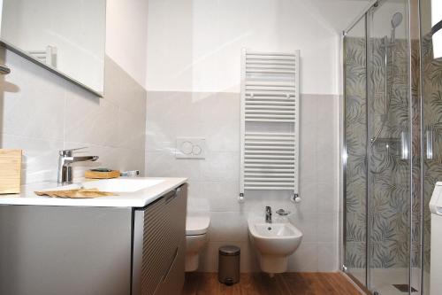a bathroom with a toilet and a sink and a shower at La Perla del Lago in Luino