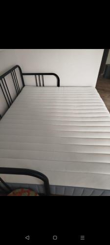 a white bed with two chairs in a room at Casa Domingos Cales De Mallorca in Calas de Mallorca