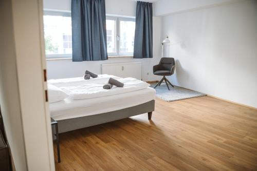 a bedroom with a bed and a chair in it at Wilten 1 in Innsbruck