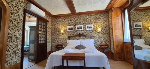 a bedroom with a large bed with white sheets at Appartamento La Torre in Lenno