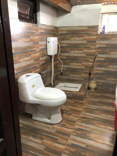 a bathroom with a toilet in a room at Burj Hotel Kottli Sattian in Ban