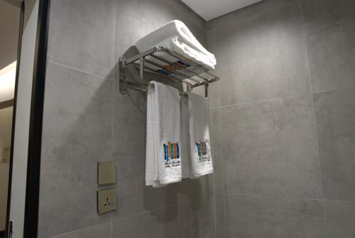 a bathroom with two towels and a shower at Royal Palace Hotel - Al Olaya in Riyadh
