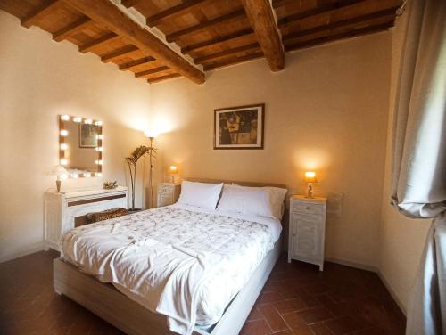 a bedroom with a large white bed with two night stands at Il sogno di Tania in Pescia