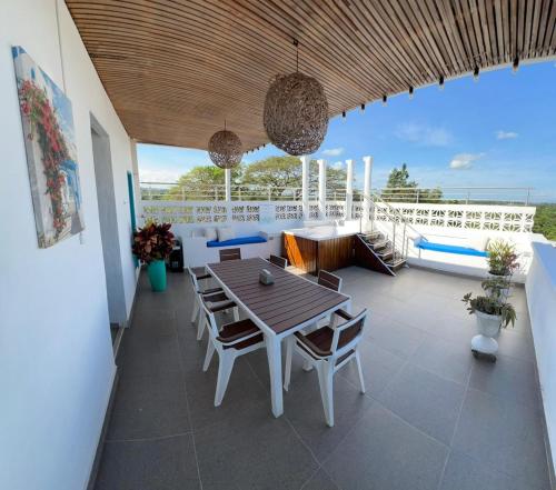 a patio with a table and chairs on a balcony at Hotel Aldea Plaza in Doradal