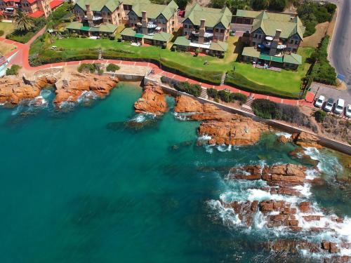 an aerial view of the cliffs next to the ocean at Beacon Wharf , George Hay 6 Seafront Accommodation in Mossel Bay