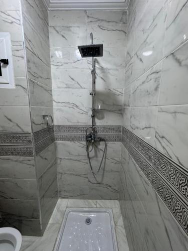 a bathroom with a shower and a toilet at Al Hoceima - Vue sur la mer- Green Village Trougout in Al Hoceïma
