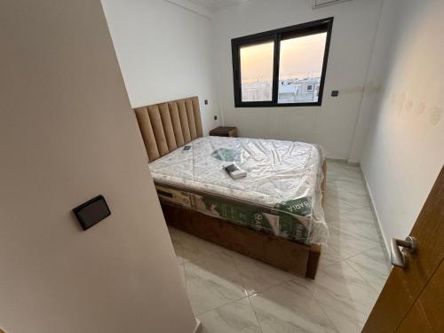 a small bedroom with a bed and a window at Al Hoceima - Vue sur la mer- Green Village Trougout in Al Hoceïma
