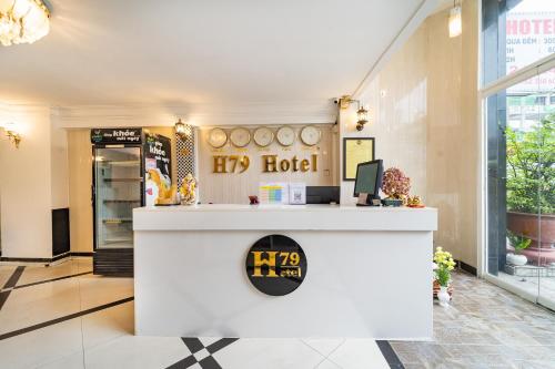 a hotel lobby with a counter with a sign on it at MÊ KÔNG HOTEL - Hotel H79 in Ho Chi Minh City