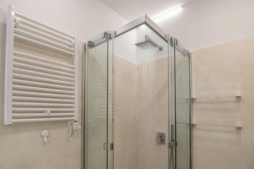 a shower with a glass door in a bathroom at Apartma Svetlo udobje v Piranu - Bright Comfort Apartment in Piran in Piran