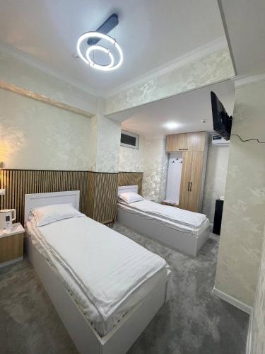 a bedroom with two beds in a room at Rest hotel in Samarkand