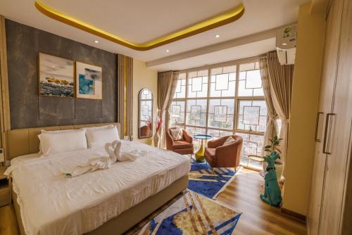 a bedroom with a bed and a large window at Himalayan Heights Penthouse in Pātan
