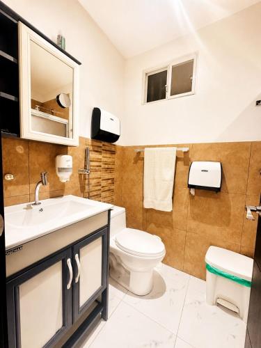 a bathroom with a toilet and a sink at Sweet Home in San Guillermo