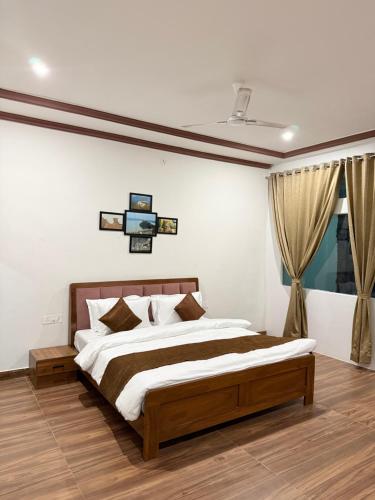 a bedroom with a large bed and a window at Jawai Mount Town in Mori Bera