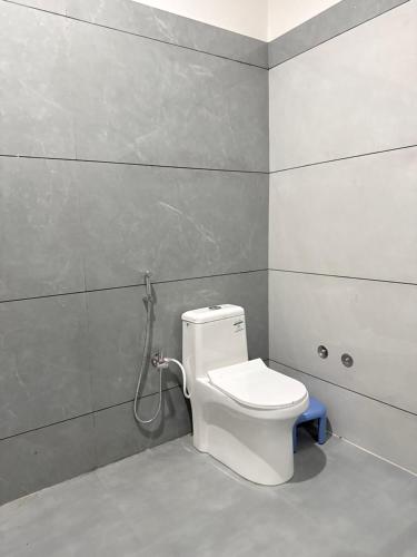 a bathroom with a white toilet and a shower at Jawai Mount Town in Mori Bera