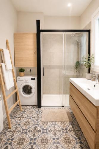 a bathroom with a shower and a washing machine at CaL QuEROL Select One in Puigcerdà