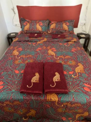 a bed with two red pillows on top of it at La barraca del pescador in Denia