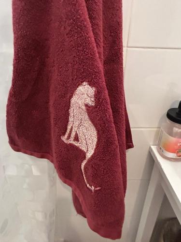 a towel with a dog on it hanging in a bathroom at La barraca del pescador in Denia