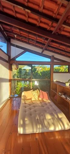 a bedroom with a bed and a large window at Casa Miralago in Santana do Riacho