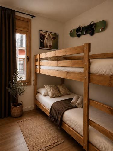a bedroom with two bunk beds and a skateboard on the wall at CaL QuEROL Select One in Puigcerdà