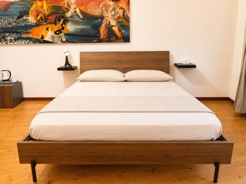 a bedroom with a bed with a wooden headboard at Milano Brenta Suites Room for 4 in Milan