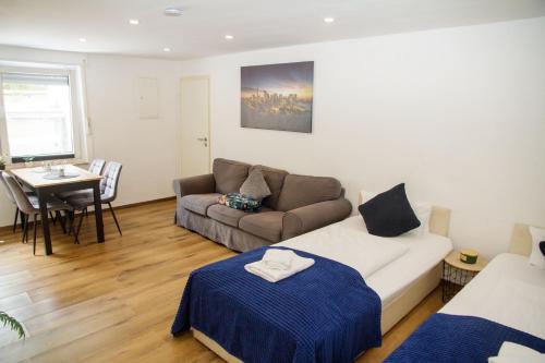 a living room with a couch and a table at Apartment für 3, 2 Boxspringbetten, Internet & Parkplatz in Dortmund