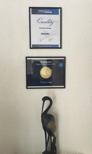 a statue of a bird standing in front of a certificate at Pension Anna in Löbau