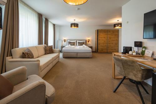 a living room with a couch and a bed at Casa Plus in Villach
