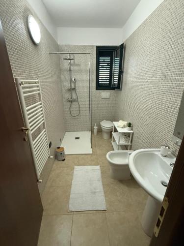 a bathroom with a shower and a sink and a toilet at La Dimora di Valesio in Torchiarolo