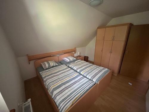 a small bedroom with a bed and a cabinet at MMMM in Bovec