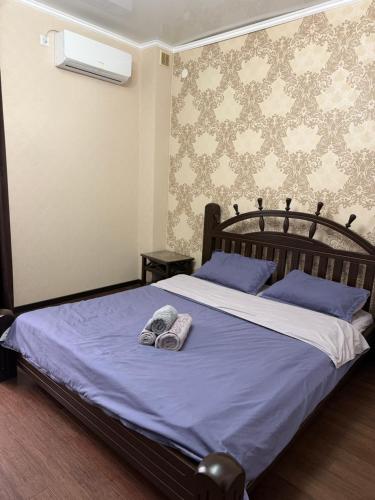 a bedroom with a bed with two towels on it at Посейдон ЖМ Амангельды ул Тепличная 4 in Kostanay