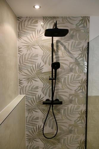 a room with a wall with a plant wallpaper at Ferienhaus Ennsling in Haus im Ennstal