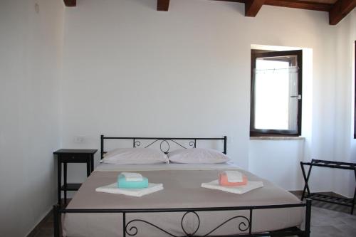 a bedroom with a bed with two towels on it at B&B del Borgo in Ortezzano