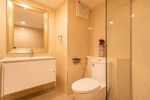a bathroom with a toilet and a sink and a shower at Hin Nan Hua Hin RELAX in Hua Hin