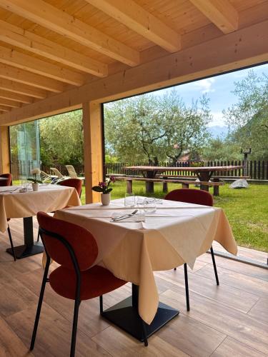 two tables and chairs on a patio with a view at Agritur Girardelli in Riva del Garda