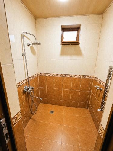 a bathroom with a shower with a window at Green dream House in Lankaran
