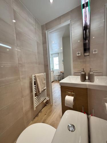 a bathroom with a toilet and a sink at La suite de Elise in Beaulieu-sur-Mer