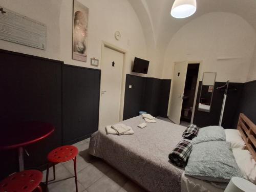 a bedroom with a bed and two red chairs at Palazzo Ruisi in Scordia