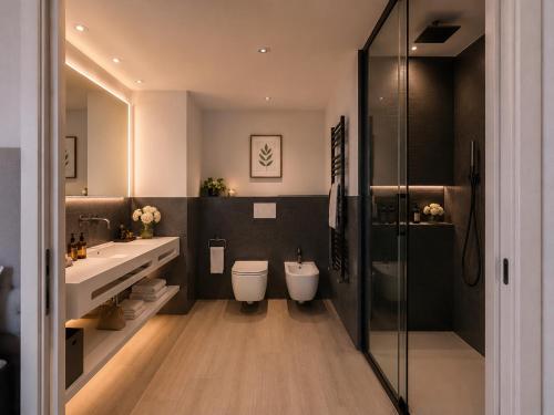 a bathroom with two toilets and two sinks and a shower at HOTEL VENICE BEACH HVB 34 Lifestyle 4 Superior in Bibione