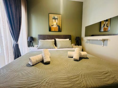 a bedroom with a large bed with towels on it at Coastal Heaven in Neoi Epivates