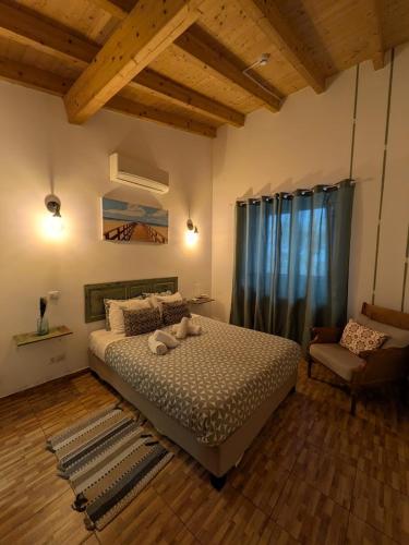 a bedroom with a large bed and a chair at Orange3 Hostel in Lagos