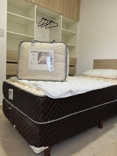 a suitcase sitting on a bed in a room at Añelo Garden Inn in Añelo