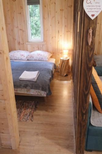 a room with two beds in a log cabin at Agroturystyka Ranczo u Oli in Krynki Białokunki